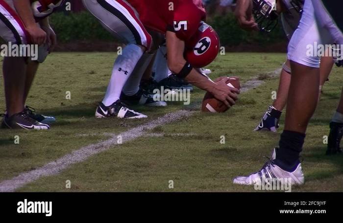 Prior to instruction a teacher/coach lets the football team scrimmage